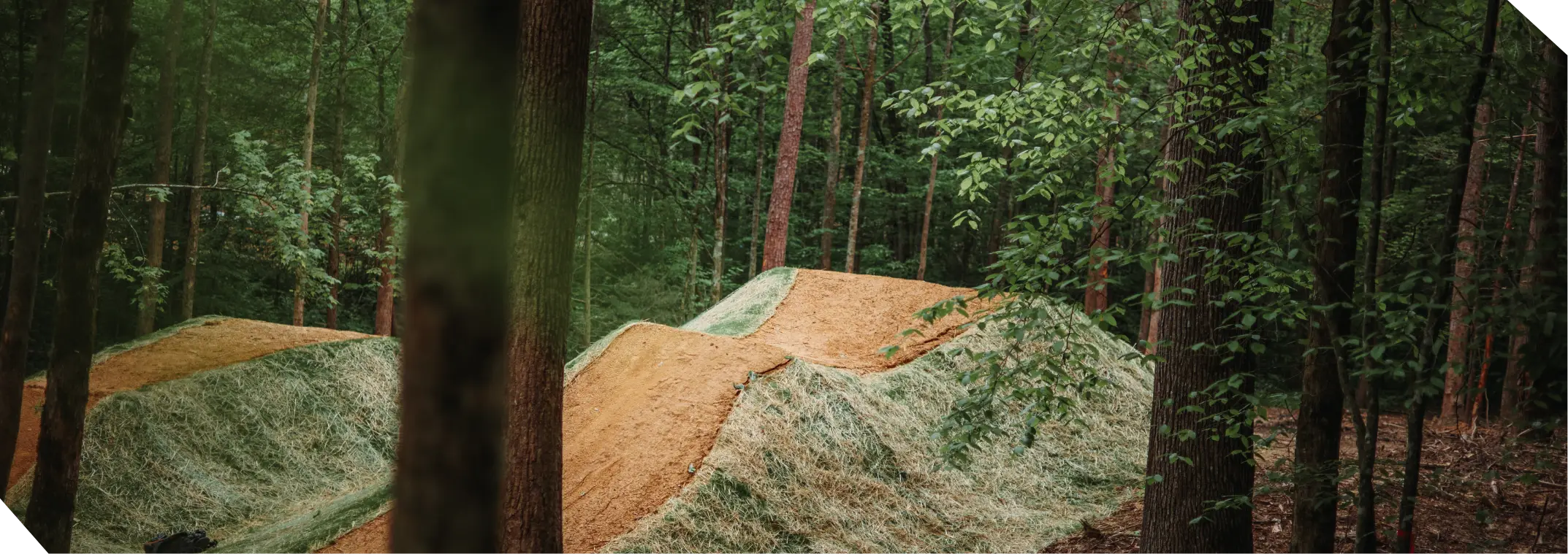 Dirt mountain bike ramps on mountain bike trail at WildSide park