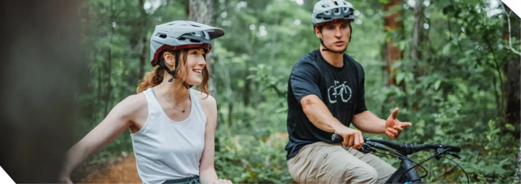 Man and woman talking while sitting on their bikes and preparing to ride again