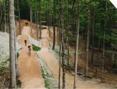 Two mountain bikers riding their bikes on The Park's Jump Track