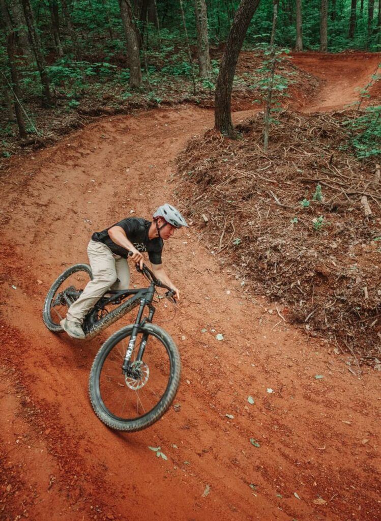 Mountain biker navigating a steep downhill section on an advanced trail in the Smoky Mountains.
