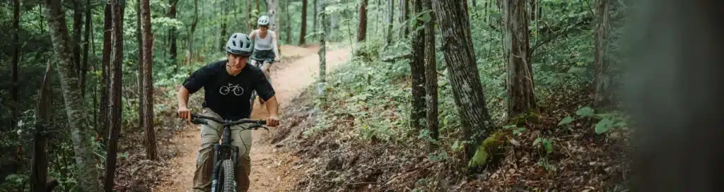 Man and woman mountain biking at WildSide's park