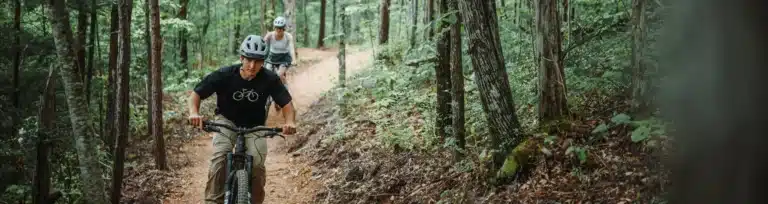 Man and woman mountain biking at WildSide's park
