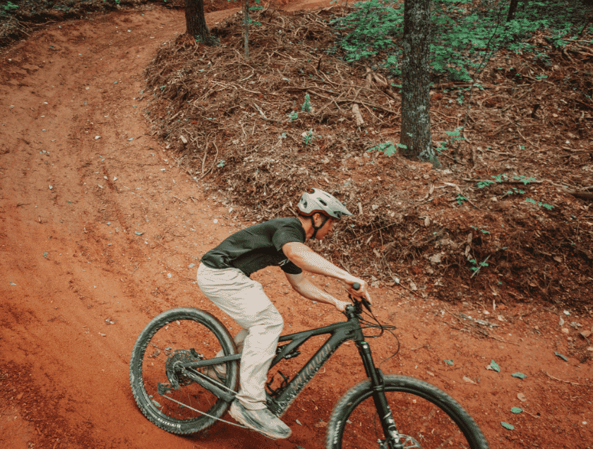 Mountain biker practices taking a tight turn while biking