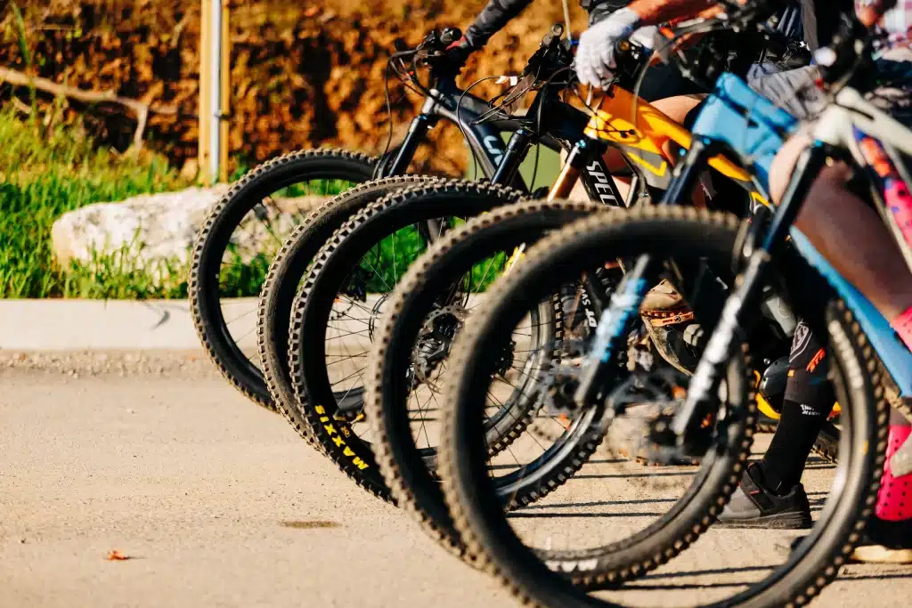 row of mountain bikes' front wheels